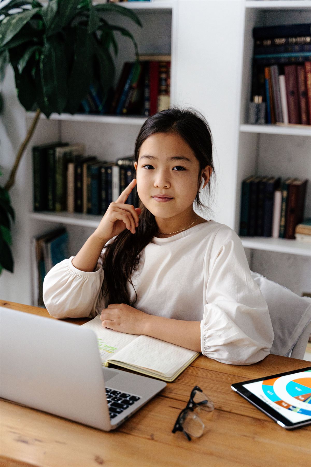 A student studying with a laptop and notebook